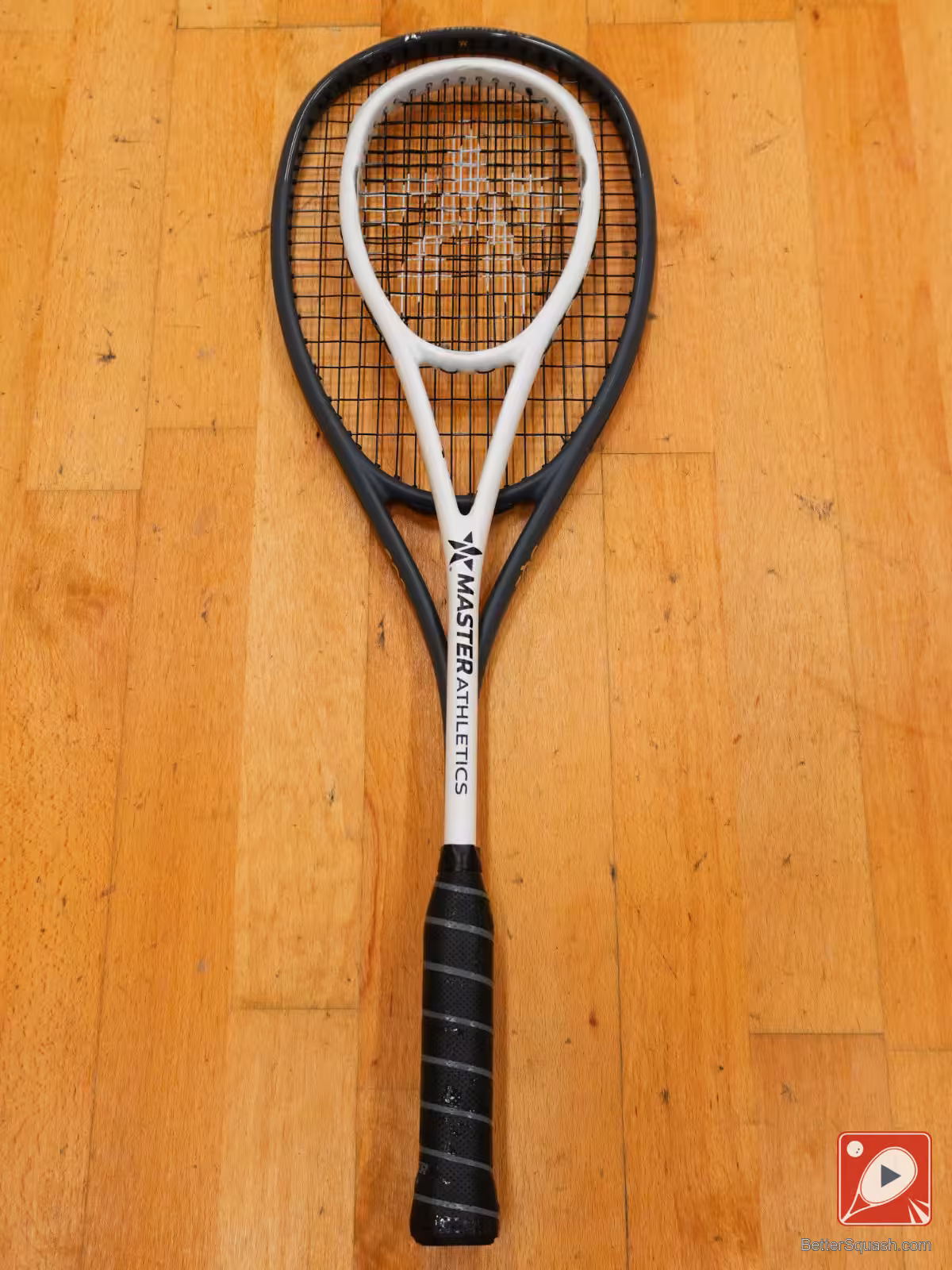 Two Master Athletics Squash Racquets lying flat on the floor